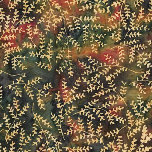 Batik yardage with branching coral motifs in red, gold, and cream on dark green