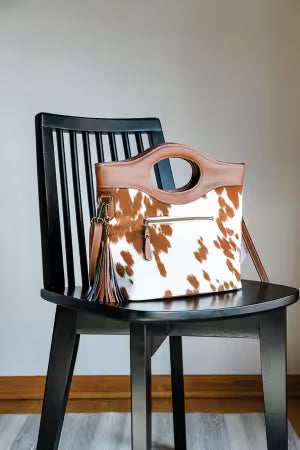 Essential bag making reference tool; cow-print tote bag with brown faux-leather straps