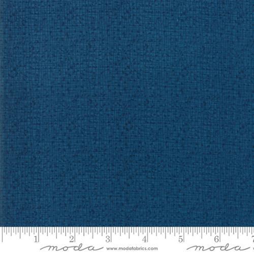 Textured blue fabric swatch, woven look with fine speckled pattern