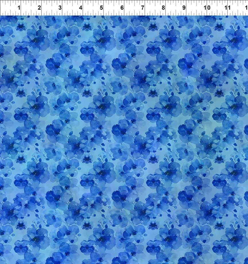 Blue watercolor floral fabric with scattered blossoms and petals