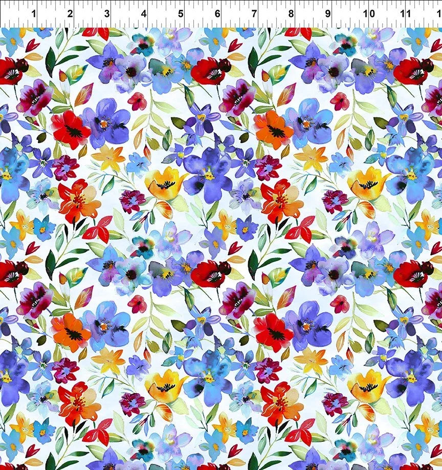Blue floral fabric with mixed wildflowers, leaves, and small blossoms repeat pattern