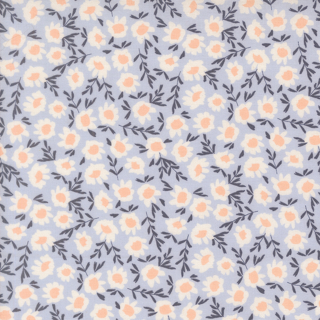 Floral quilting fabric with peach and ivory flowers and dark leafy branches on a pale blue ground