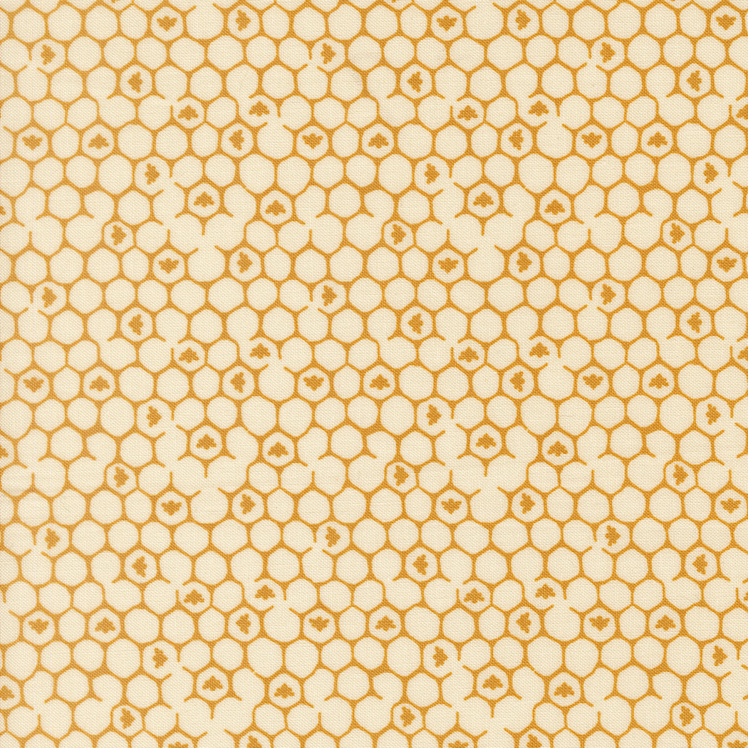 Printed cotton fabric with a cream background and repeating orange honeycomb and tiny floral motifs