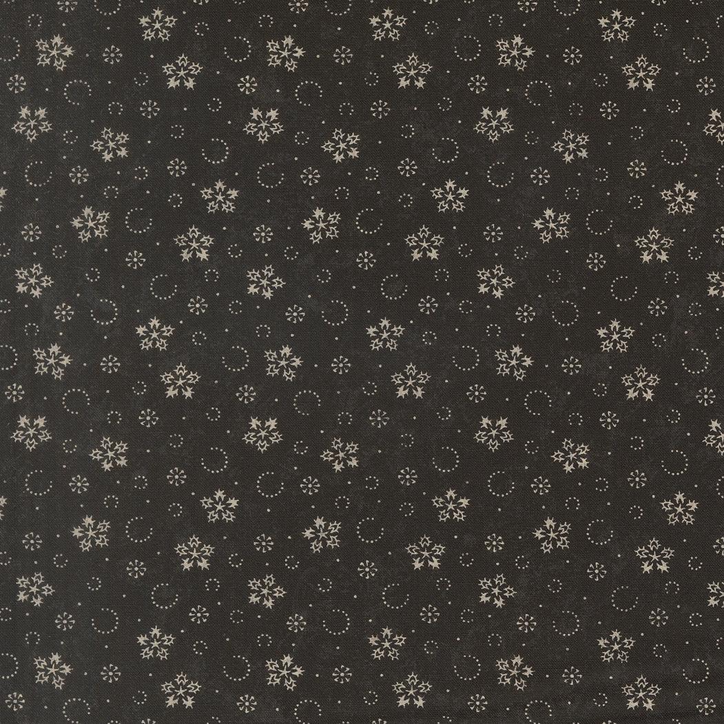 Ebony fabric with scattered gold snowflakes, circles, and small star motifs