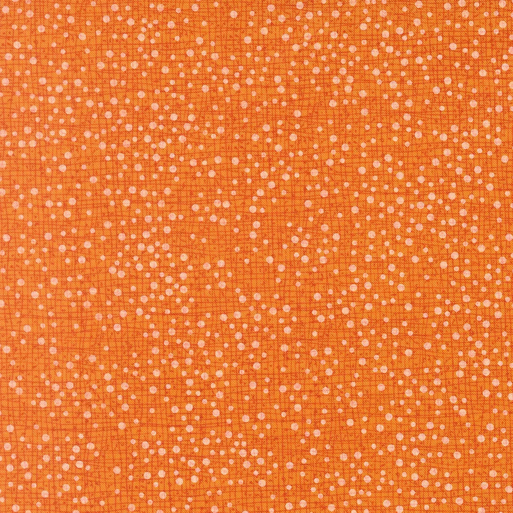 Orange quilt fabric with small scattered white dot pattern