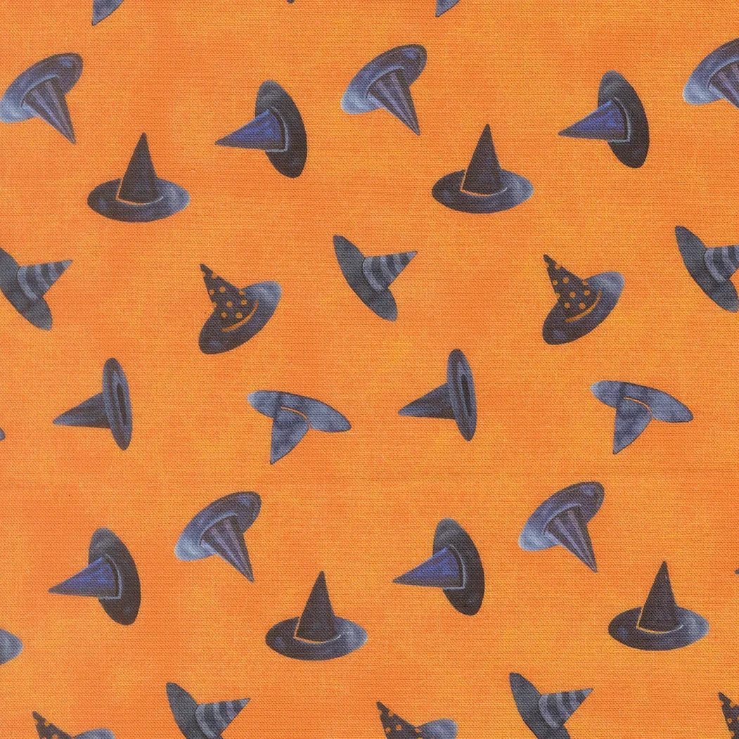 Orange fabric with scattered black and gray witch hats