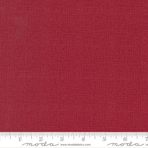 Red textured fabric with subtle woven crosshatch pattern