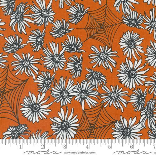 Orange cotton quilting fabric with black-and-white daisy flowers and web-like leaves