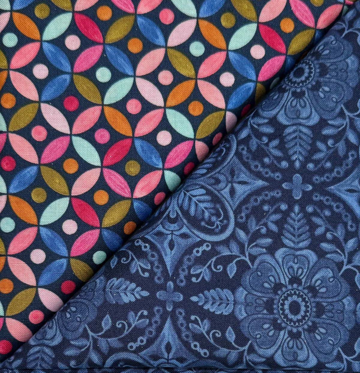 Table runner with multicolor circular poppy pattern and navy damask side panels