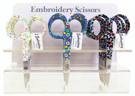 Embroidery scissors set with colorful patterned handles, shown on clear display stand