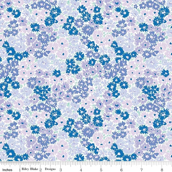 Floral cotton fabric with small blue and purple flowers on a light background