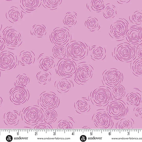 Purple fabric with repeating circular rosette swirl pattern; includes edge measurement ruler