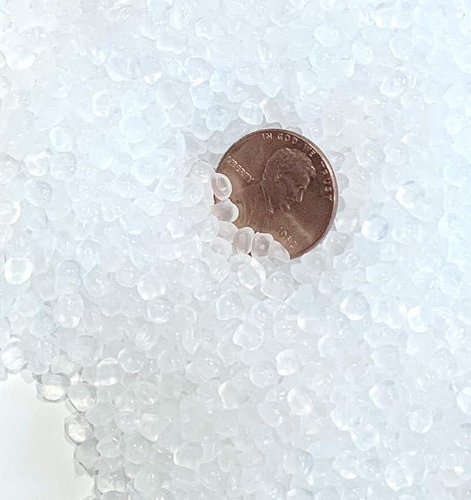 White poly pellets filling beads with a coin for size
