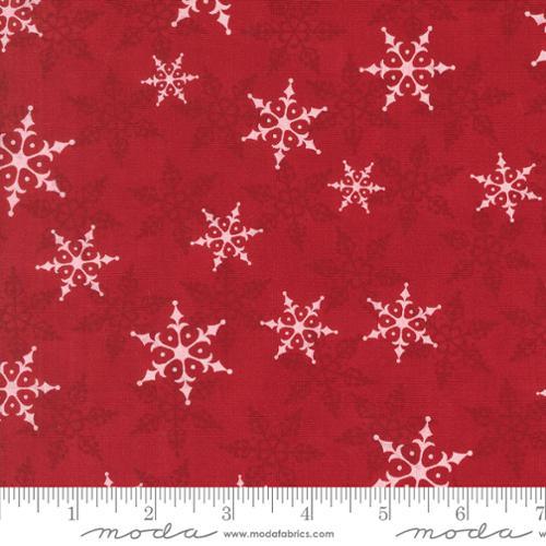 Berry red cotton fabric with white snowflake motifs by Moda Fabrics