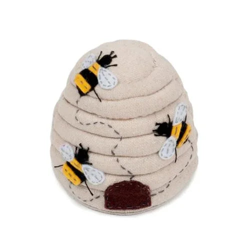Beehive pincushion with embroidered bees on beige fabric, round maroon base
