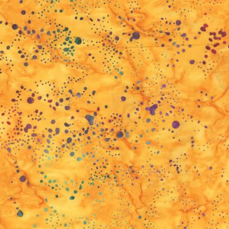 Batik fabric with orange-yellow base and multicolor splatter dot pattern
