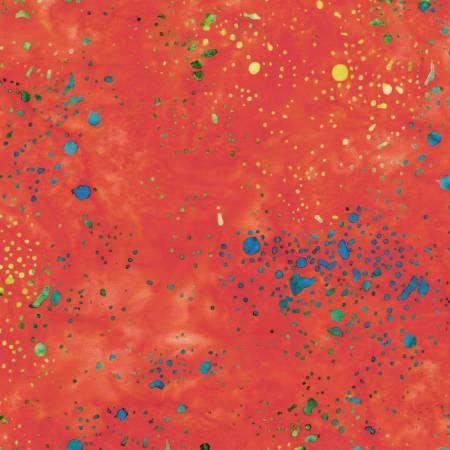 Batik cotton fabric with red-orange base and multicolor paint splatter pattern