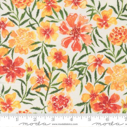 Floral fabric close-up with coral, orange, and yellow blossoms and green foliage
