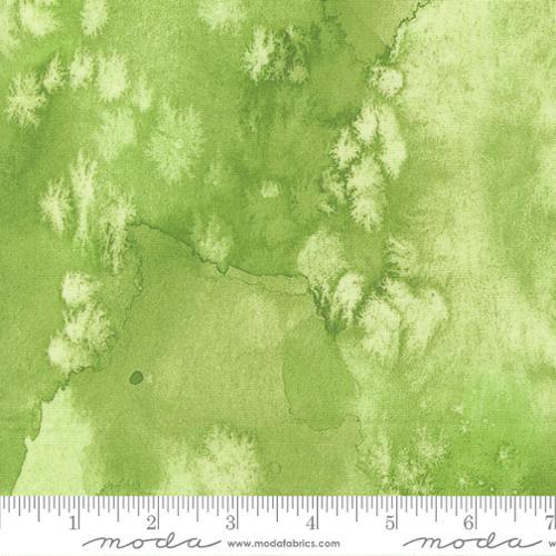 Green fabric with pale white abstract splash and sprig pattern