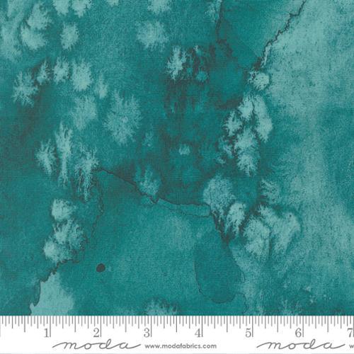 Turquoise fabric with white mottled leaf clusters and distressed texture