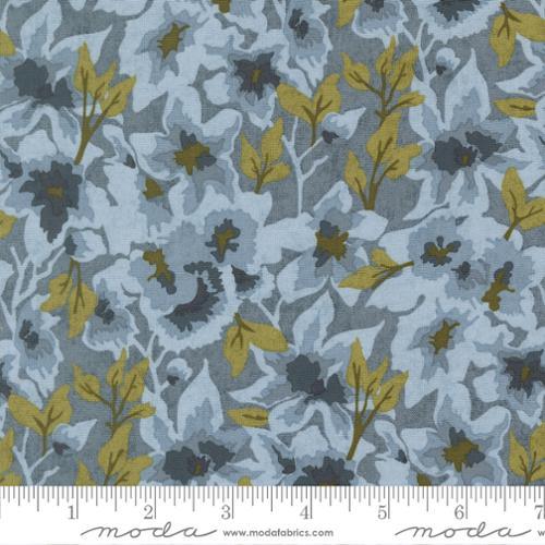 Cotton quilting fabric with light blue ground and scattered yellow-green floral leaves