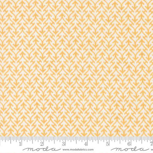 Cotton fabric with white arrow trellis pattern on golden yellow background