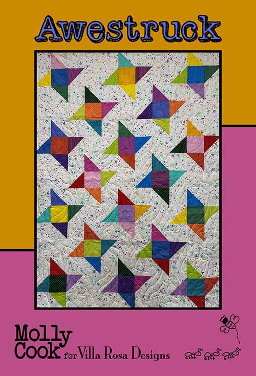 Multicolor star-pattern quilt with geometric blocks on light fabric