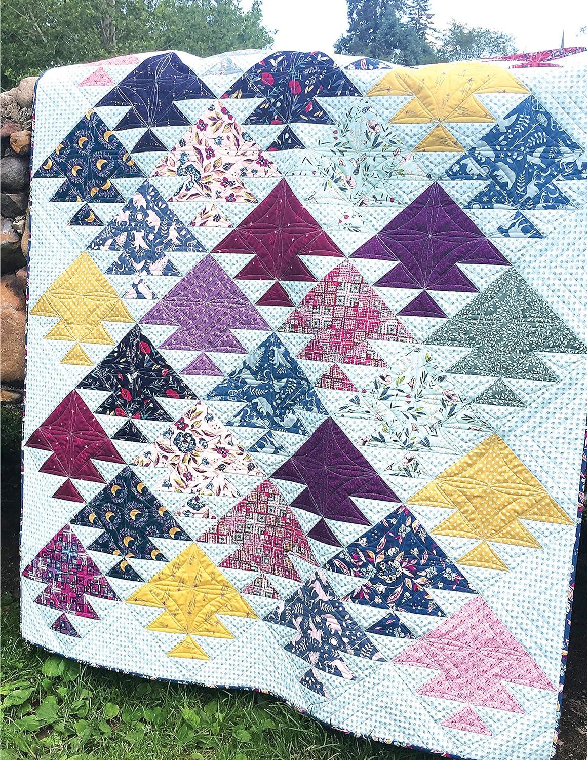Patchwork quilt with stars, triangles, and colorful blocks on a light fabric base.