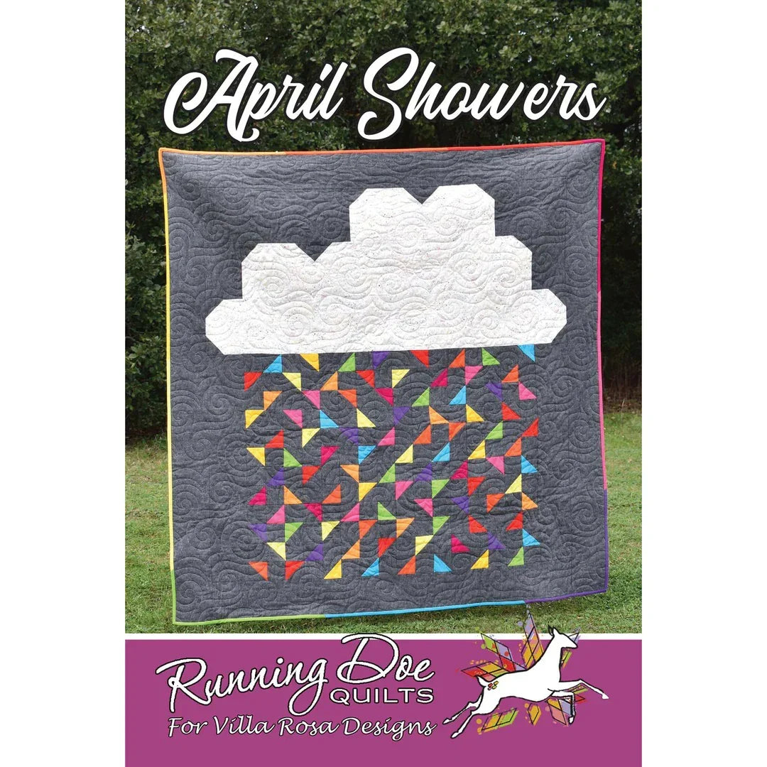 Quilt with white cloud applique and colorful geometric blocks on dark gray fabric