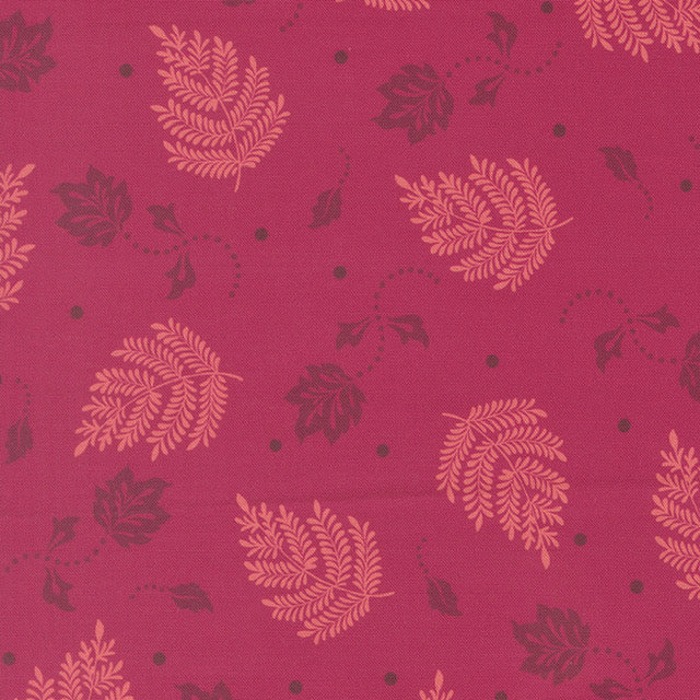 Quilting cotton fabric with scattered leaf and paisley motifs in pink and plum
