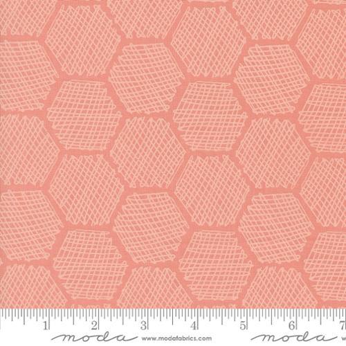 Carnation pink honeycomb fabric with white geometric hexagon grid