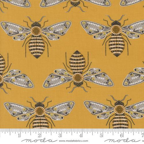 Honey yellow fabric with repeating metallic bumblebee and flowerlike wings pattern