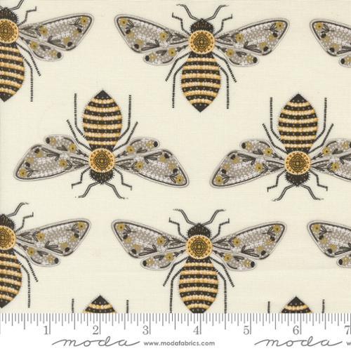 Off-white fabric with metallic gold and black bumblebee motifs in repeating pattern
