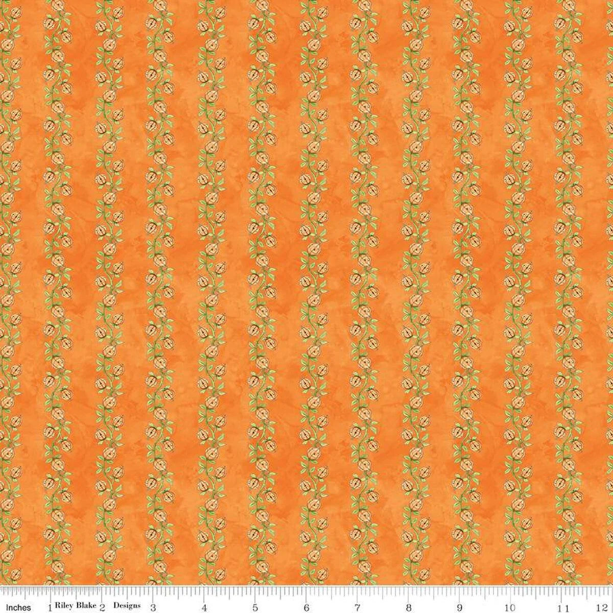 Orange cotton fabric with repeating pumpkin vine motif and small green flowers pattern