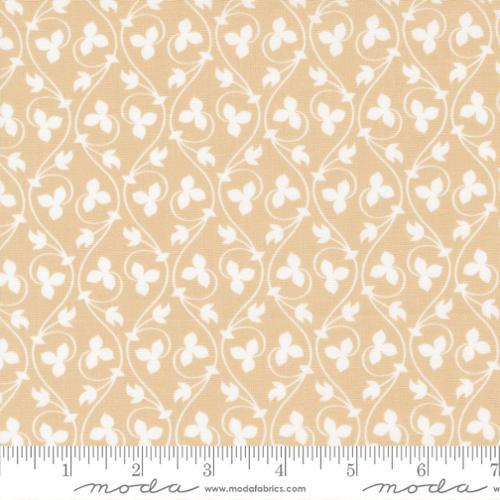 Flax fabric with cinnamon tan base and cream four-petal clover pattern
