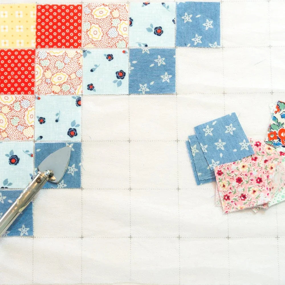Patchwork fabric grid panel set with small printed squares in red, blue, and floral designs