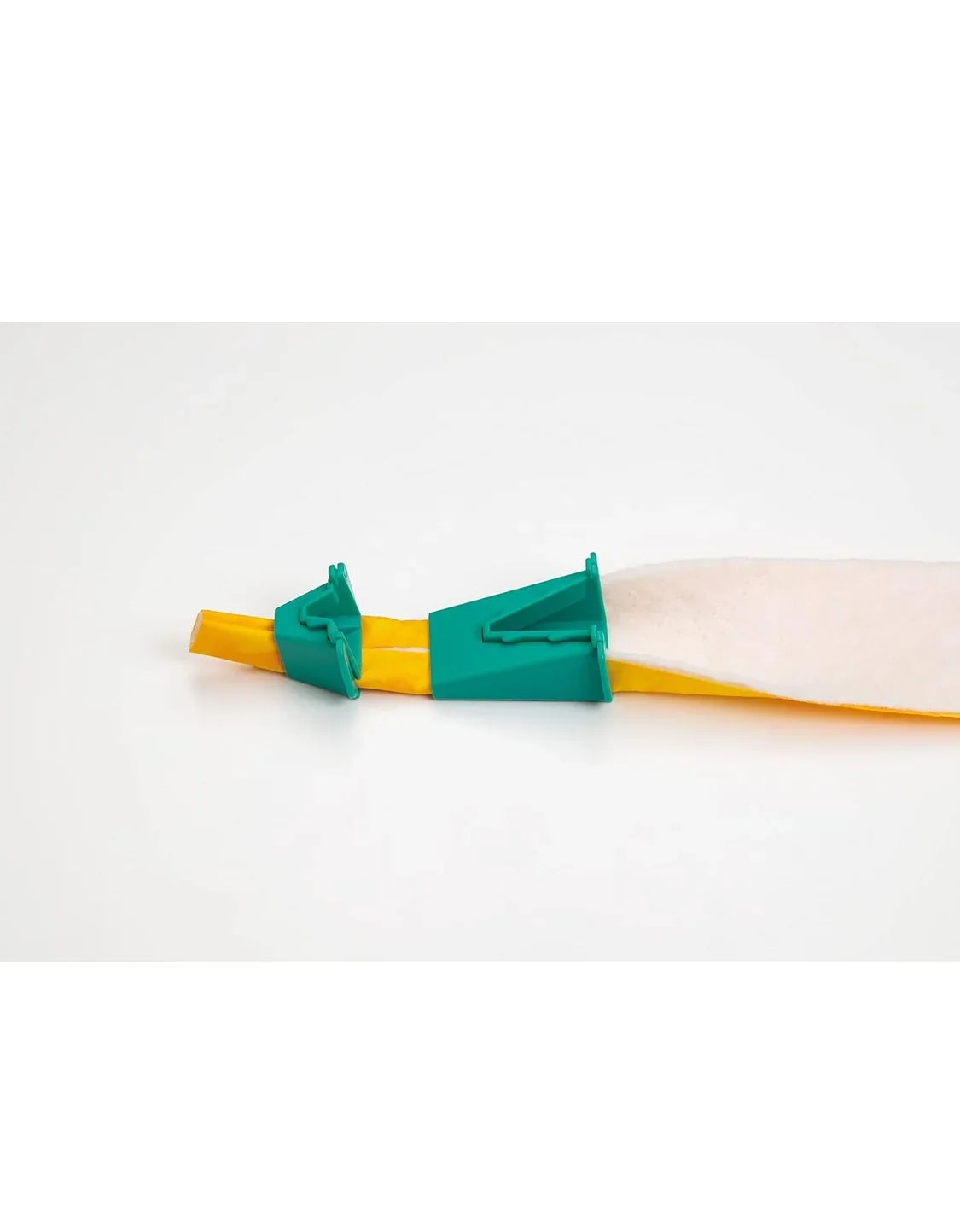 Teal tube maker guide on yellow fabric strip with rolled fabric edge