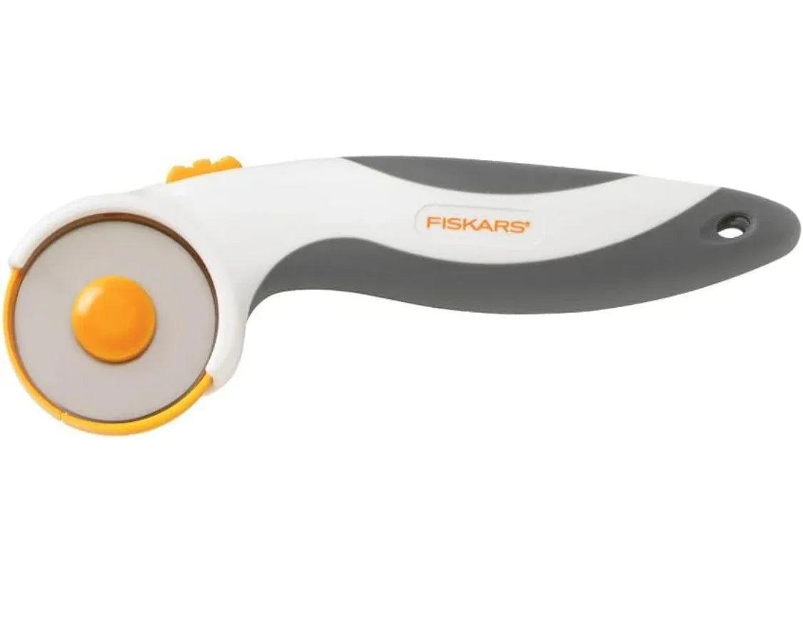 Fiskars rotary fabric cutter with gray handle and orange comfort grip loop