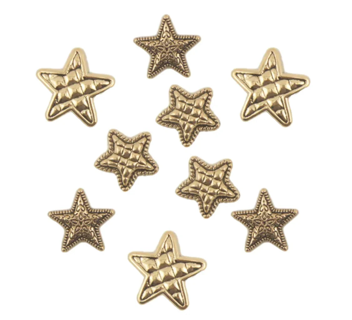 Gold star-shaped buttons with faceted ridges, multiple pieces