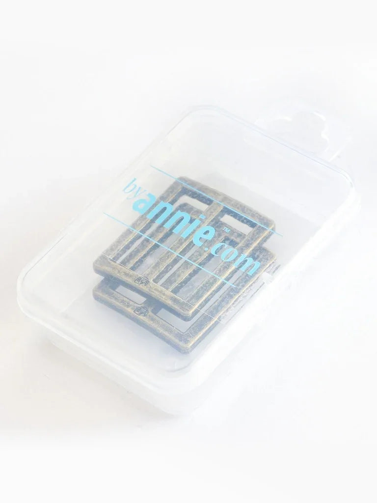 Set of two rectangle rings in clear plastic case, antique brass tone