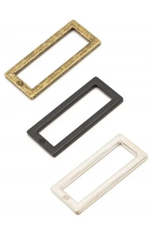 Set of two rectangular metal rings with open centers in dark and light finishes