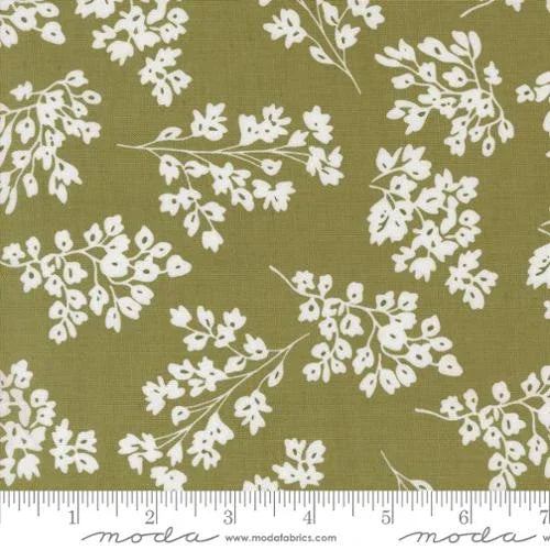 Olive-green fabric with scattered white basil-like botanical sprigs pattern
