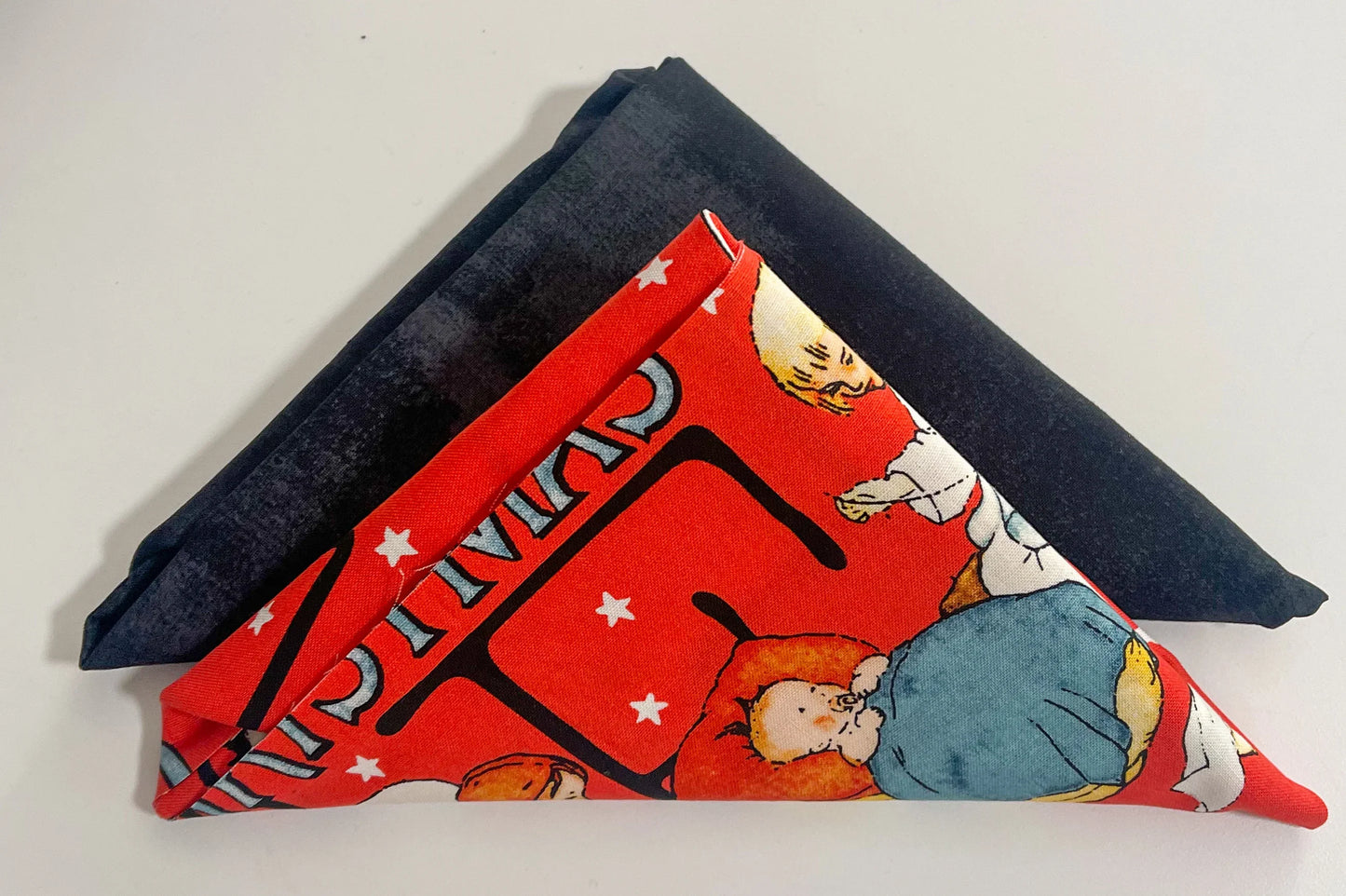 Christmas table runner with dark blue edge and red cartoon-style print panel