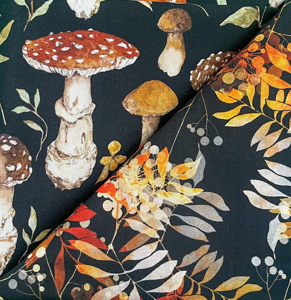 Table runner with dark fabric, colorful hedge foliage, mushrooms, and flowers pattern