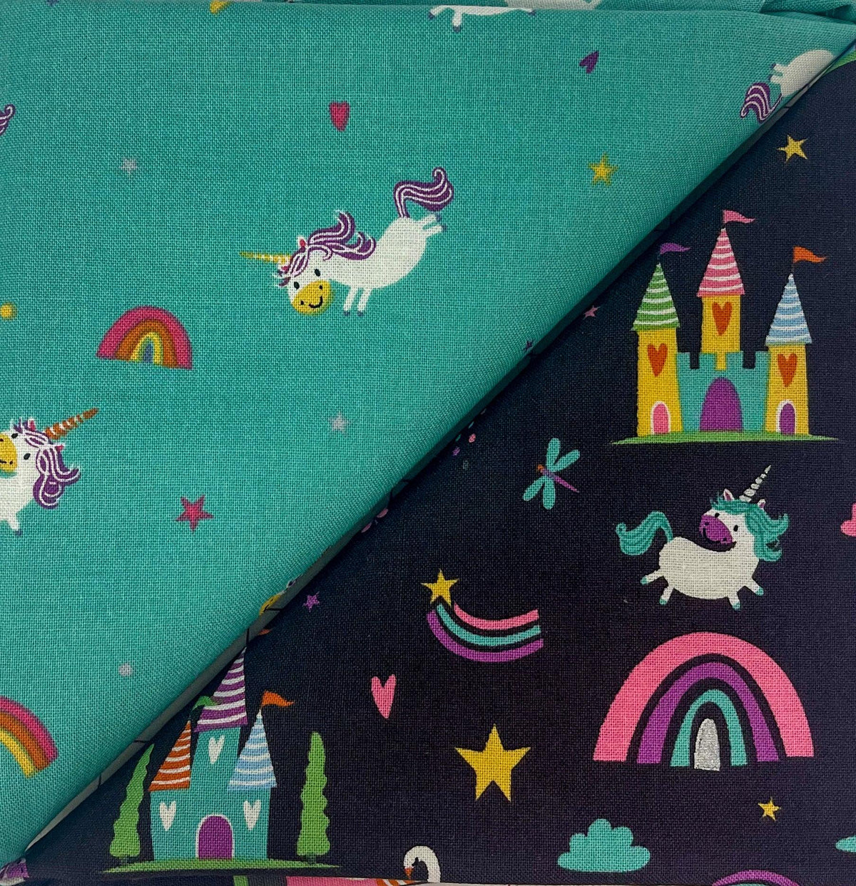 Teal and dark table runner fabric with unicorns, rainbows, and castle motifs