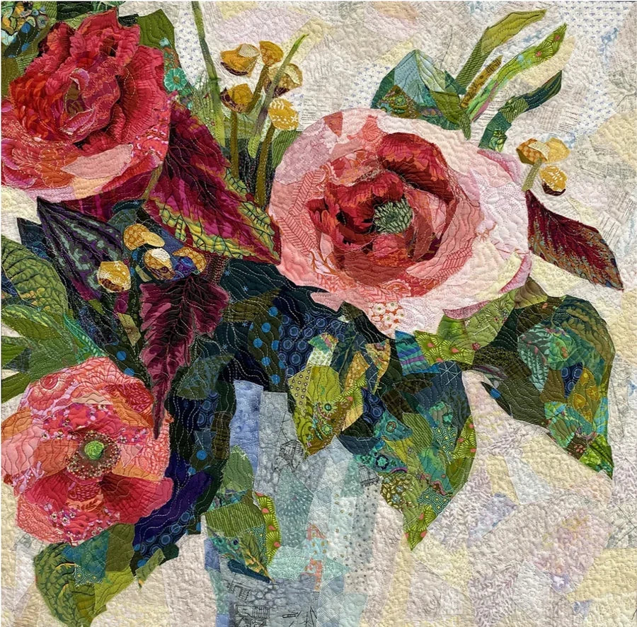 Floral collage patchwork fabric with red, pink, and green roses and leaves
