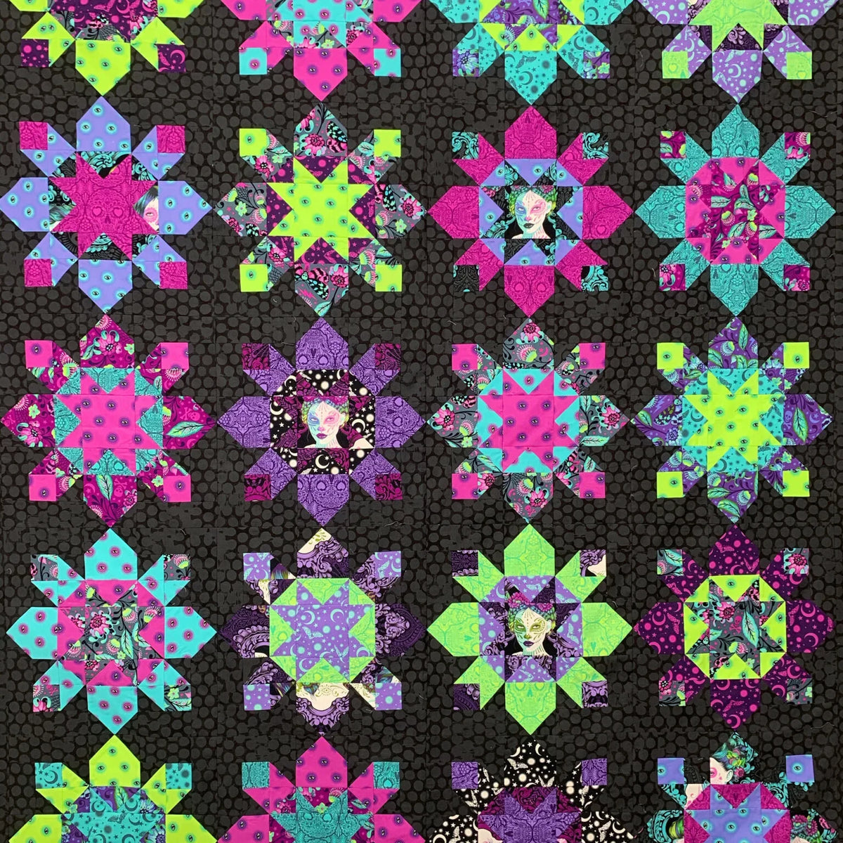 Neon starburst quilt block pattern with bright pink, lime, purple, and teal blocks