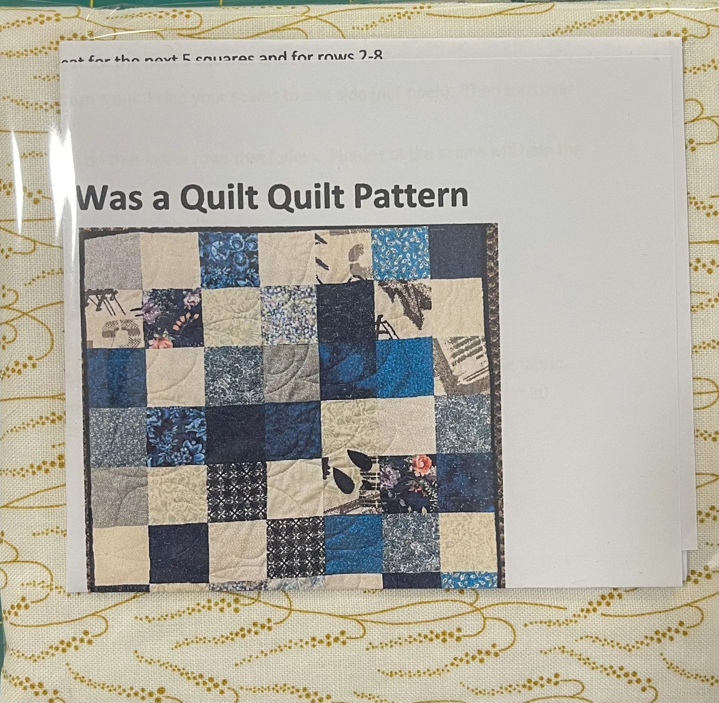 Quilt pattern with blue and cream rectangle and square patchwork diagram on paper