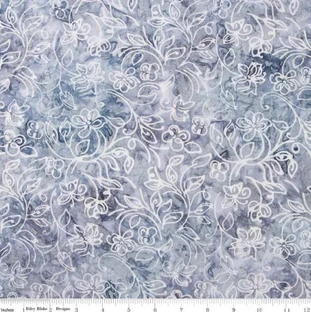 Gray batik fabric with white floral and vine swirl pattern, close-up