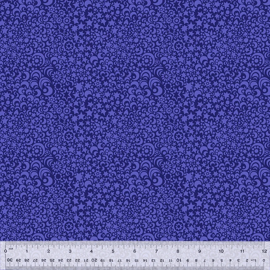 Quilt fabric with purple celestial pattern of stars, moons, and swirls.
